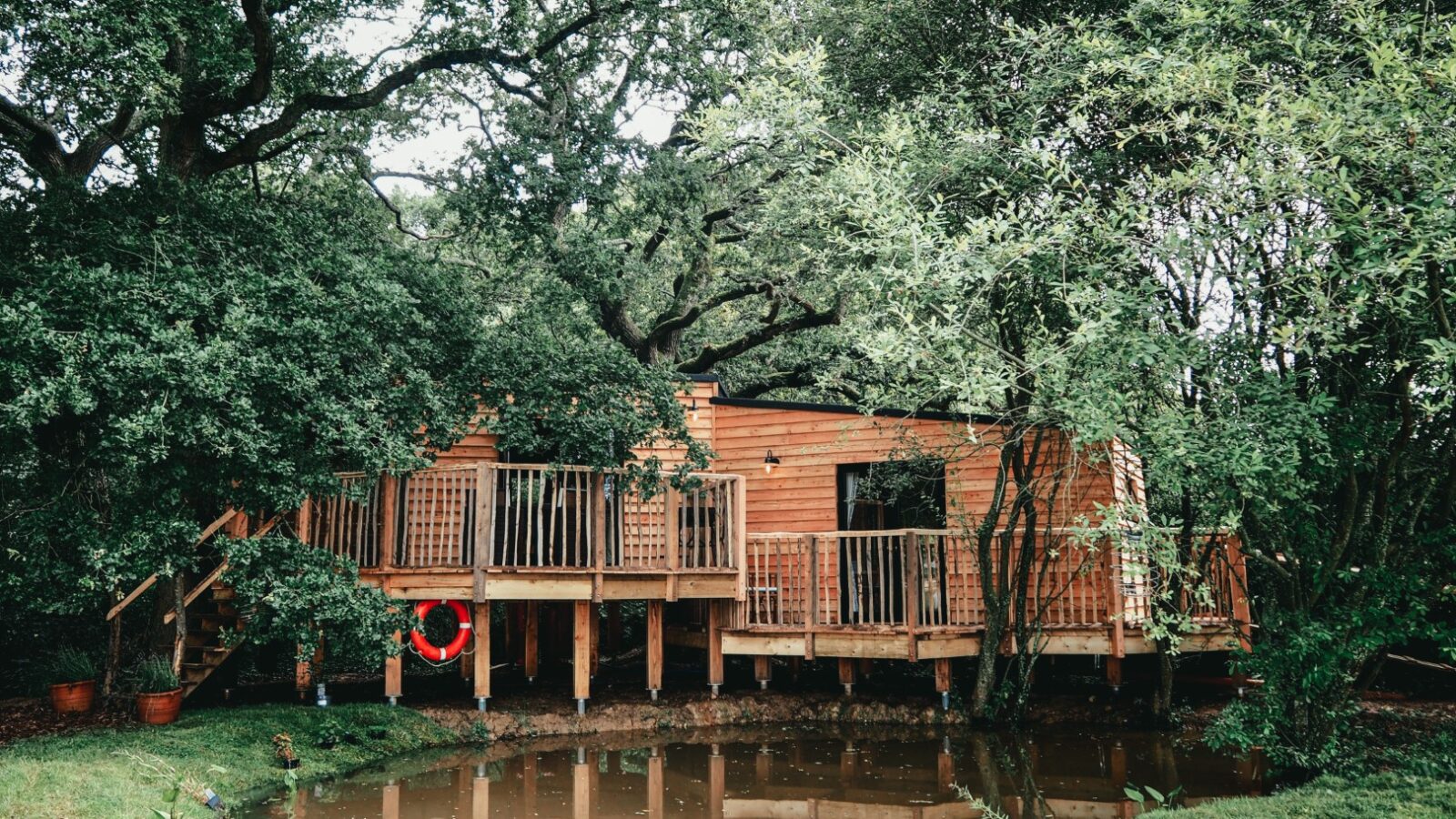 A wooden treehouse with a deck, aptly named 