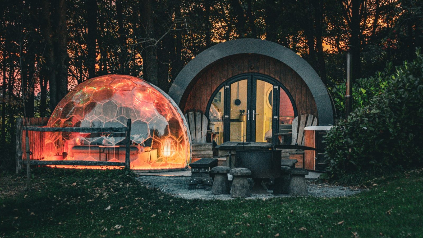 A dome-shaped tent and a wooden cabin at Catgill Farm offer sunset views amidst trees in the Yorkshire Dales.