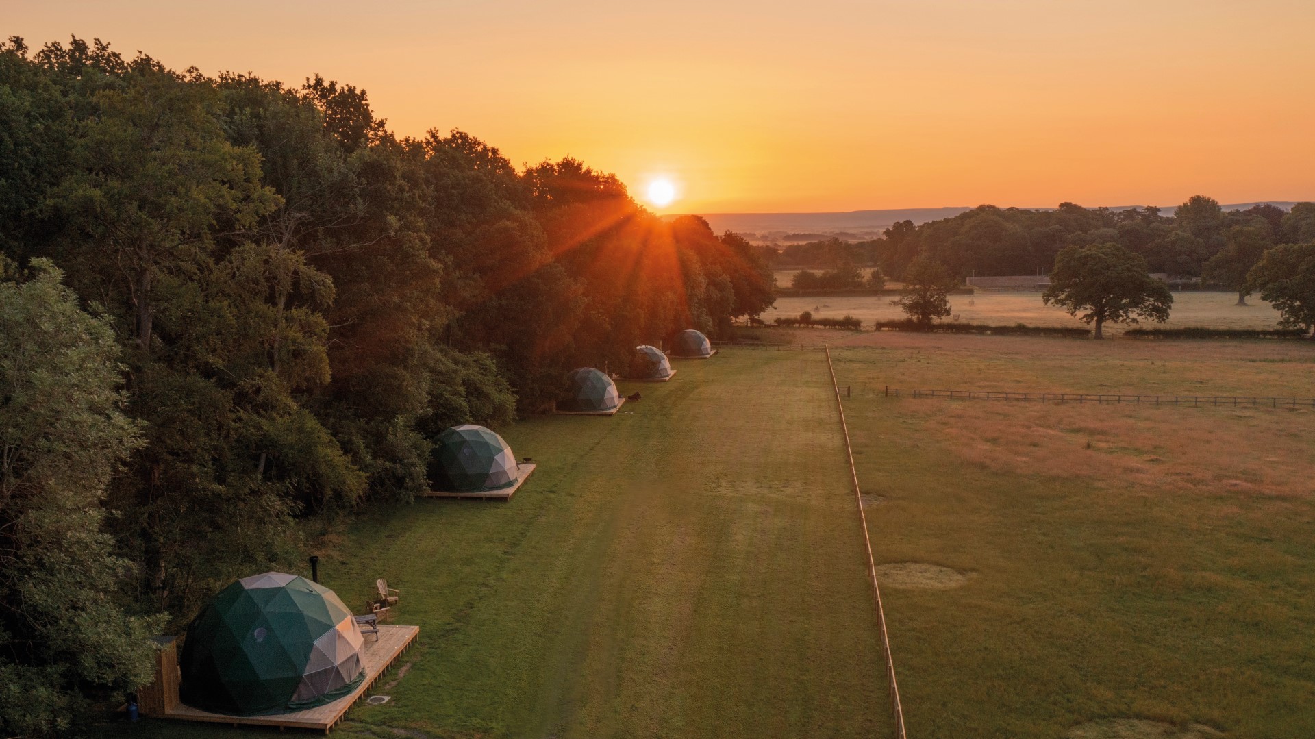 A unique geodome glamping site in North Yorkshire at sunset. Glamping UK at Camp Katur