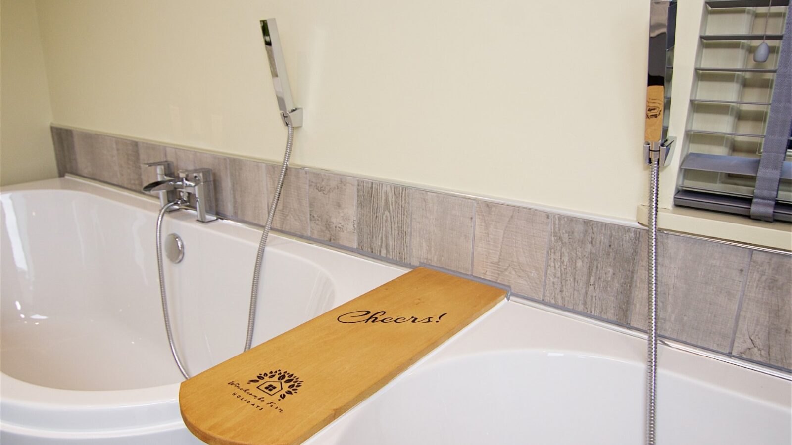 A wooden bath tray engraved with 