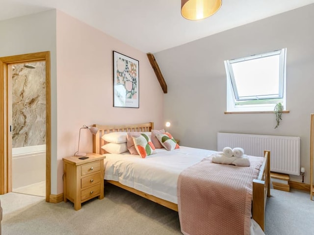 A cozy bedroom with a wooden bed frame, white bedding, and pastel-colored throw pillows and blankets. Natural light streams through a skylight window, casting a warm glow reminiscent of the Penshenkin Barn. A bedside table with a lamp is on one side, and a framed picture hangs on the light pink accent wall.