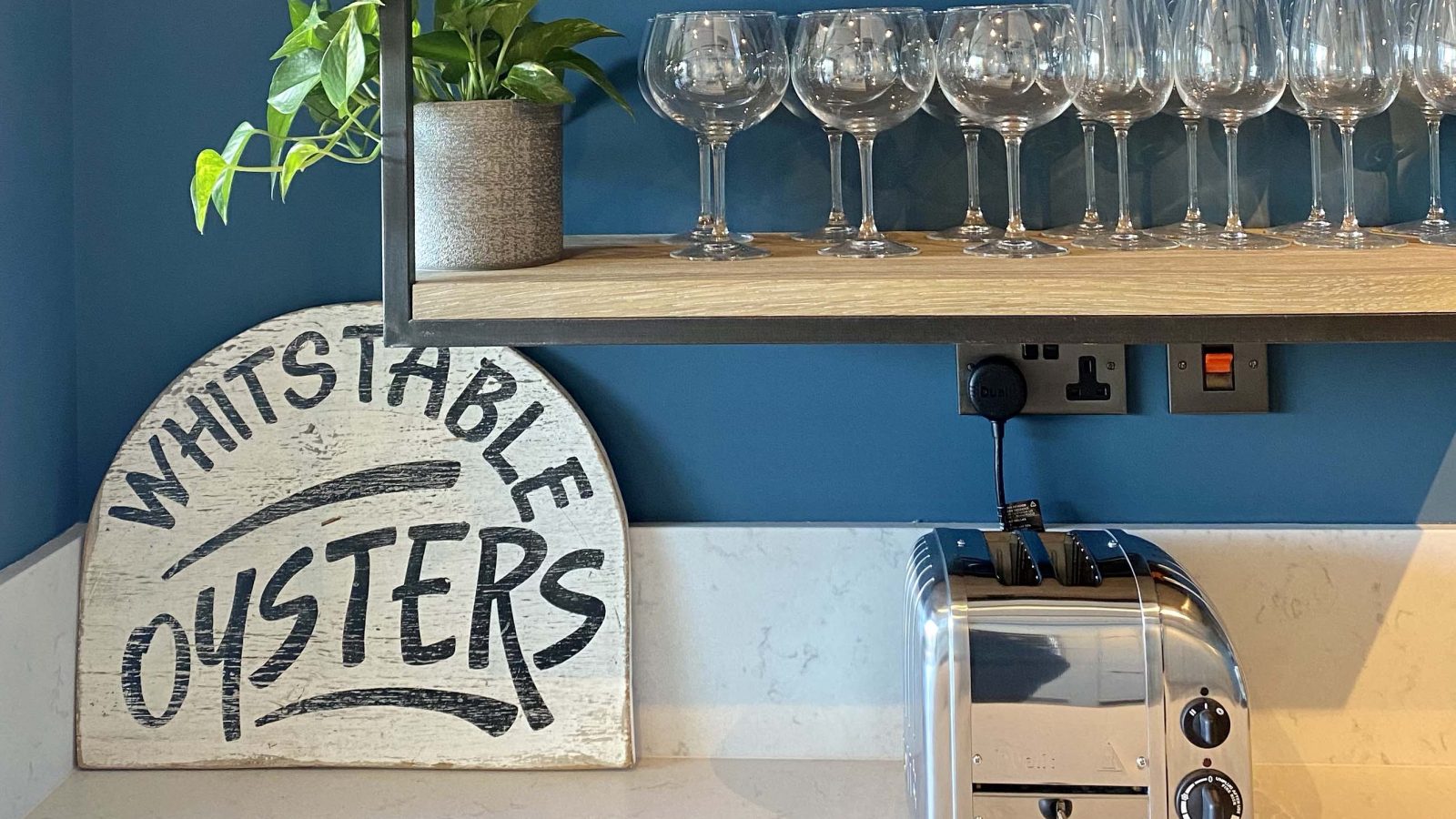 A kitchen countertop features a sign reading 