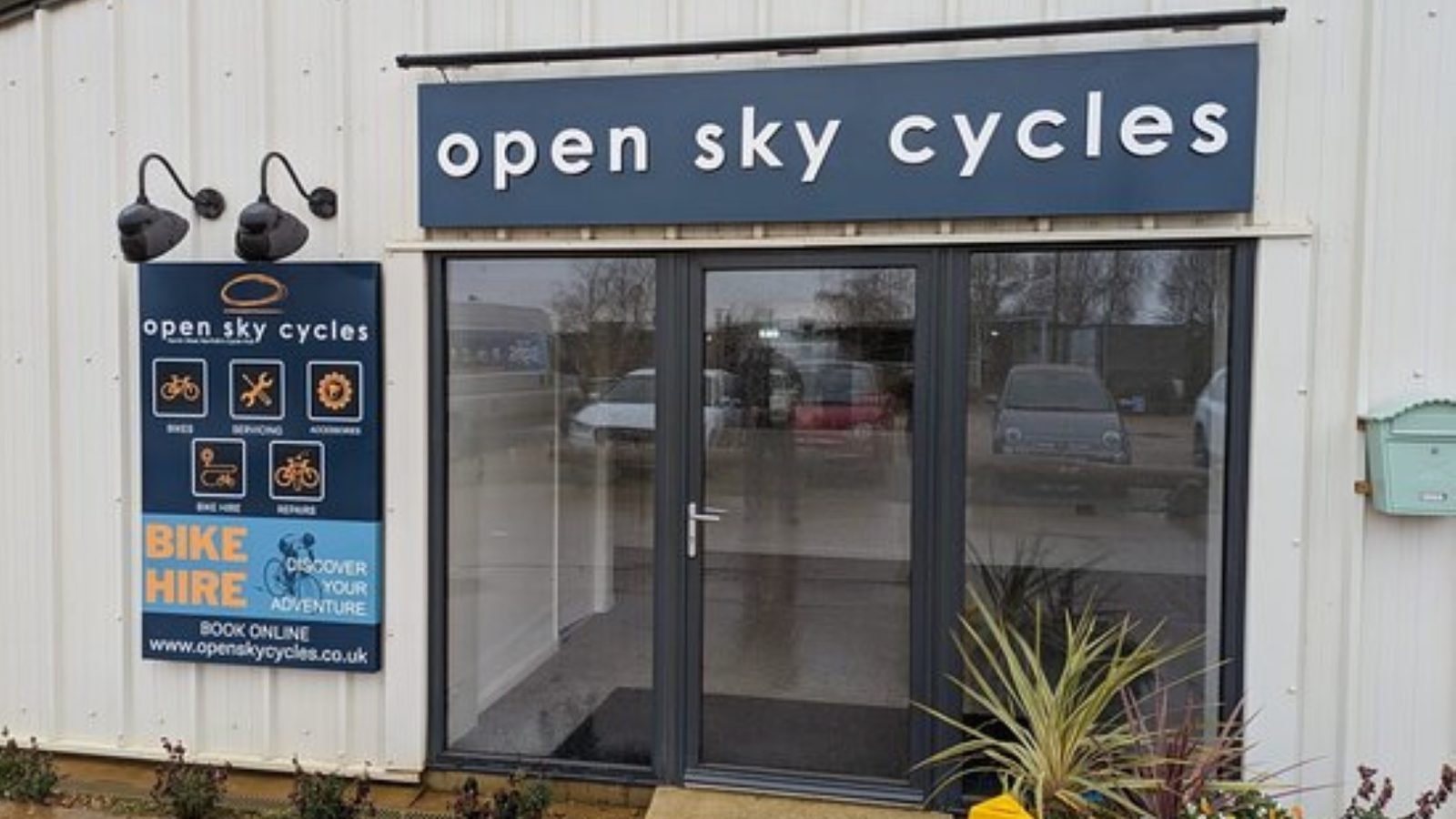 Storefront of Open Sky Cycles with a sign that reads 