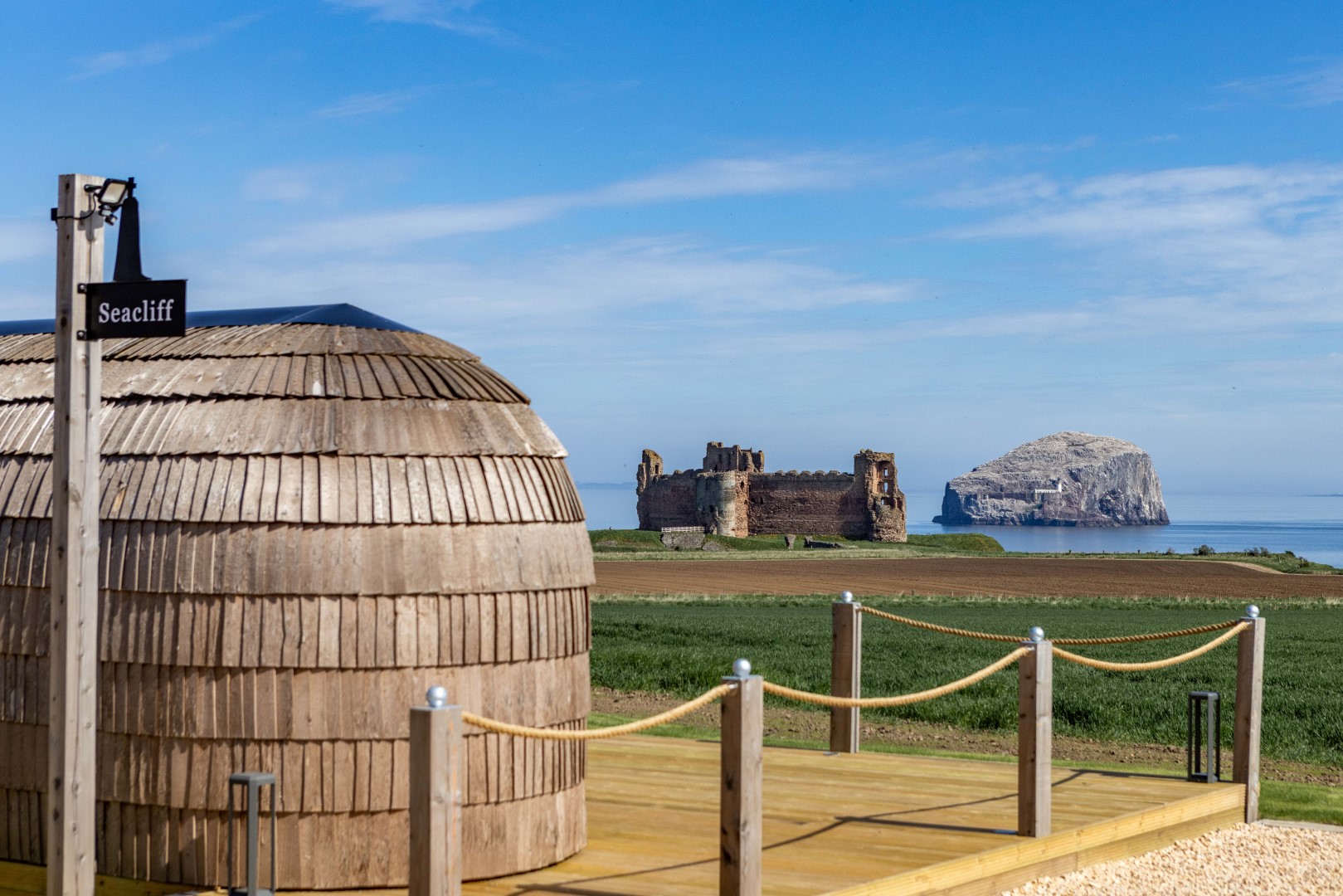 Rock & Castle Escapes Igluhut has a deck with chairs to soak in the views of the coastline | Glamping Scotland | Winter getaway UK