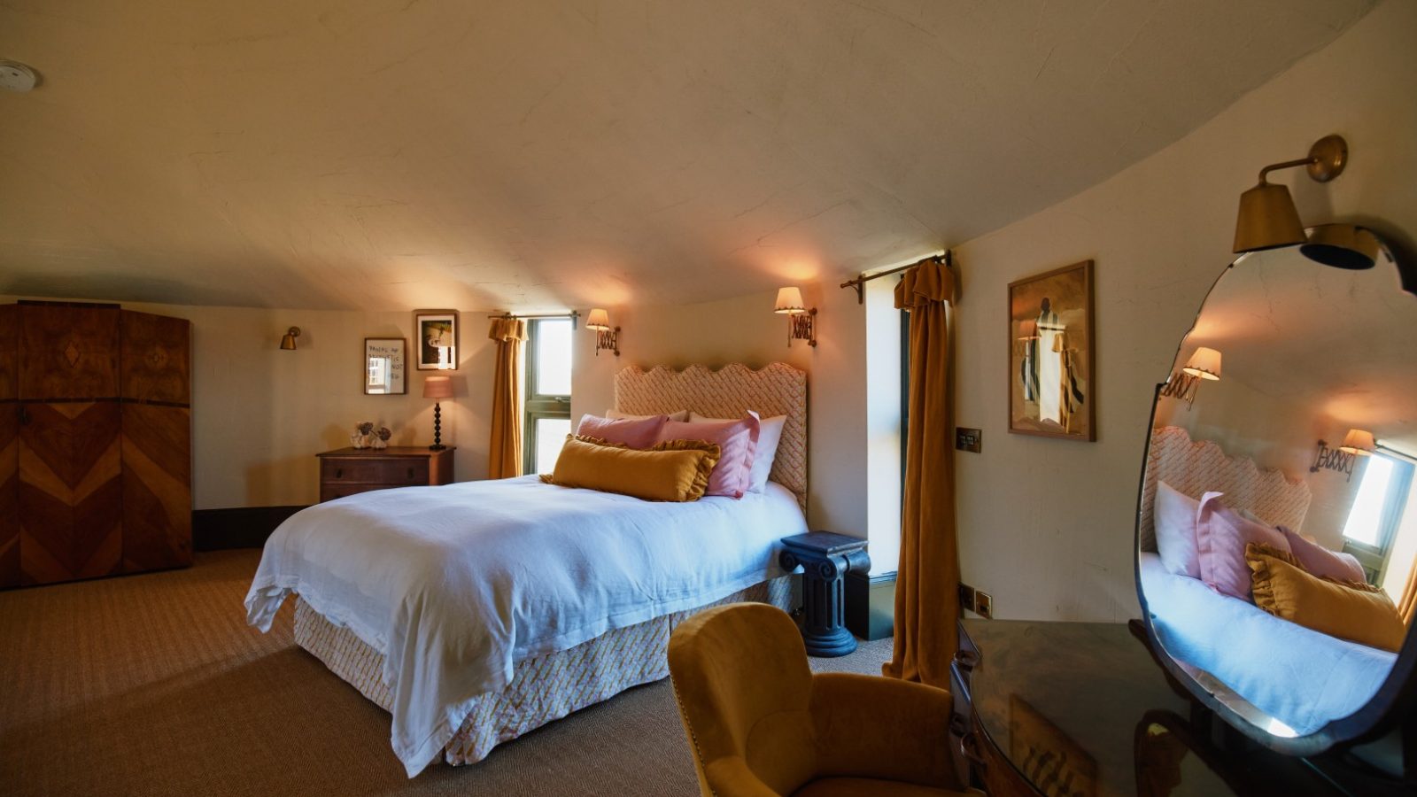 Cozy Bonington Farm bedroom with a double bed, cushioned headboard, vintage furniture, and warm lighting enhancing the ambiance.