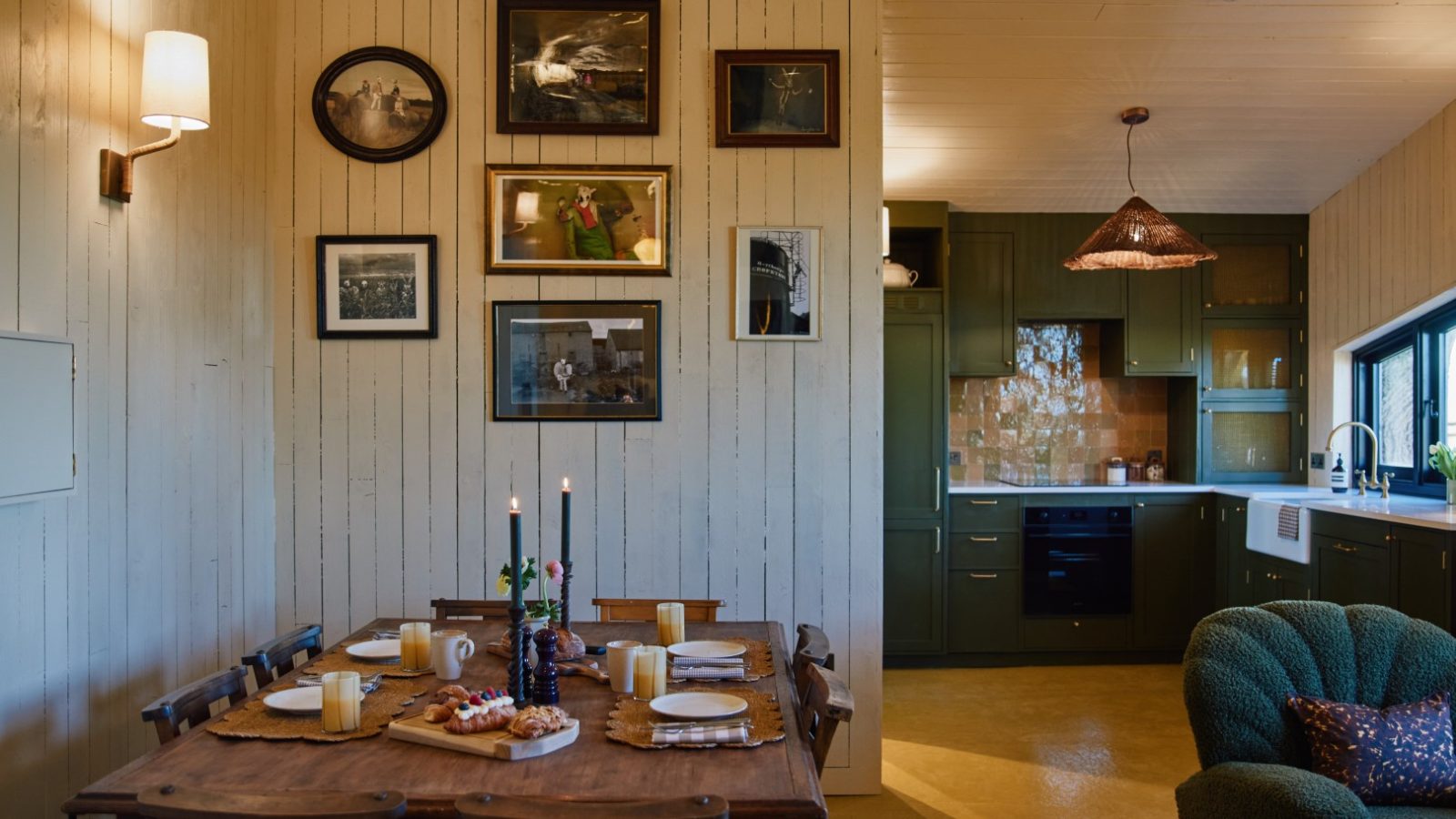 Charming dining area at Bonington Farm with a wooden table set for four, candlelit ambiance, and light wood paneling.