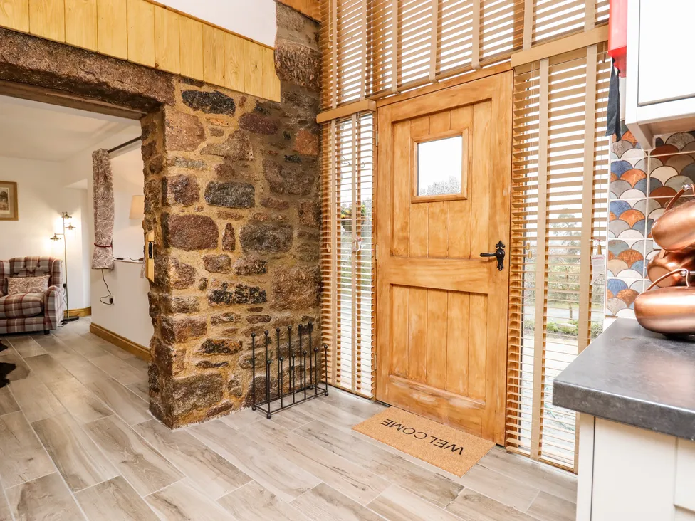 Cozy Bagtor entryway with wooden door, stone wall, 